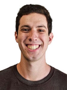Man smiling in dark brown shirt with dark brown hair in front of a white background