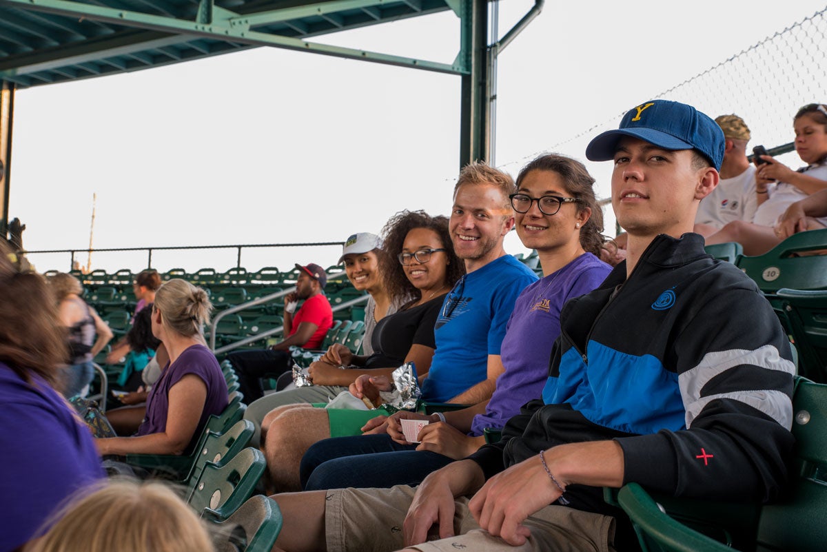 Group of students in the stands at a baseball game