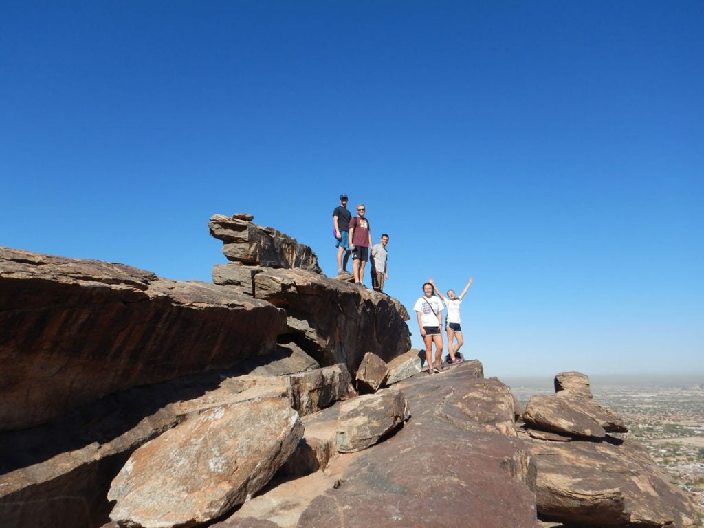 Group of students on top of rocks on a mountain