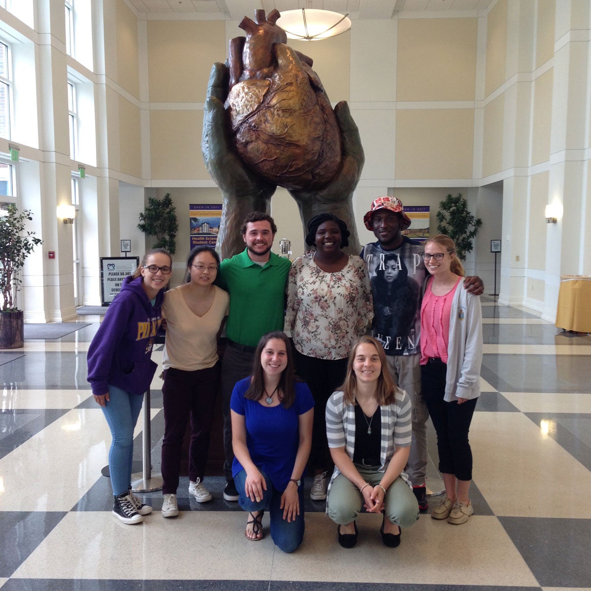 Group of students in front of heart sculpture