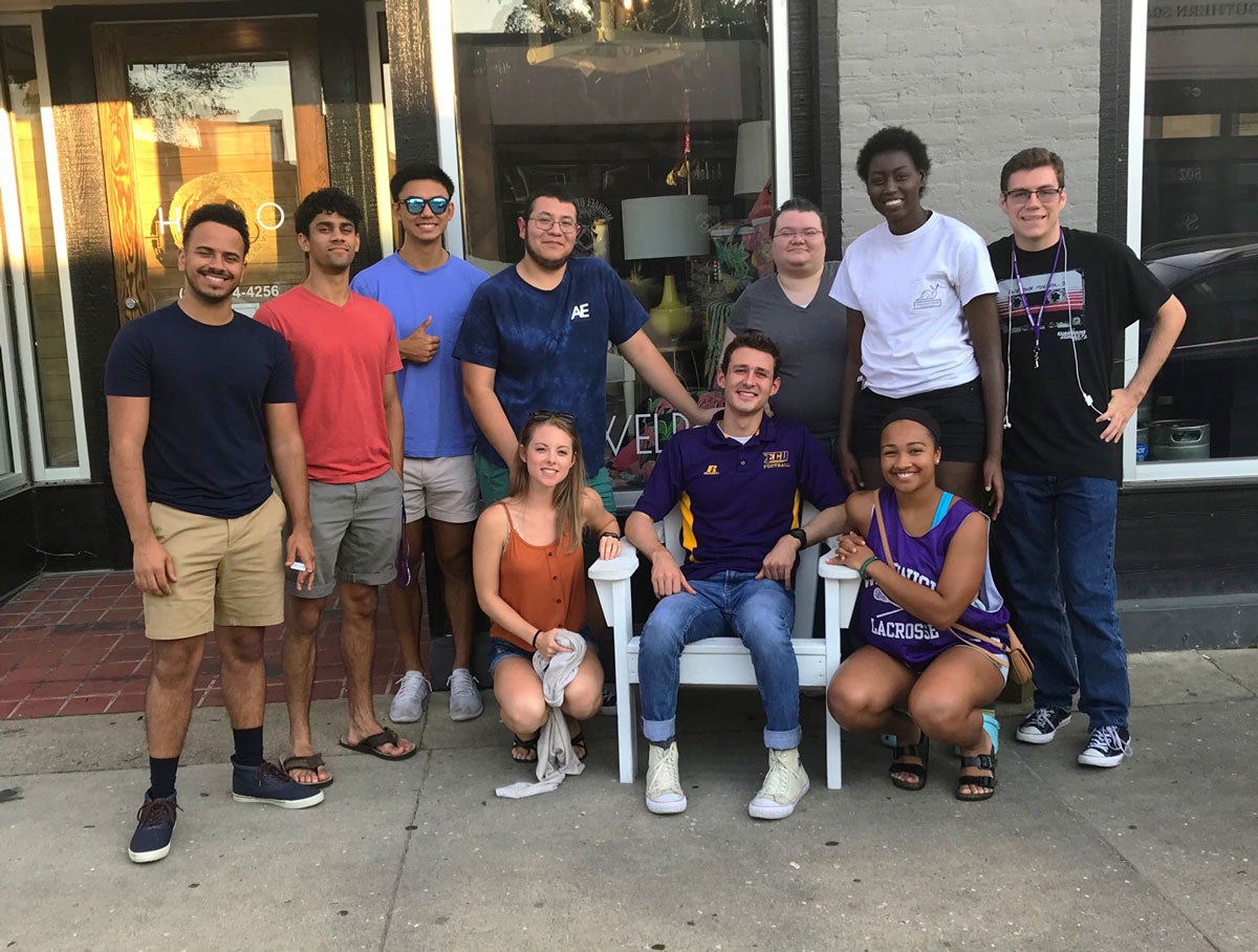 Group of students outside in front of a storefront