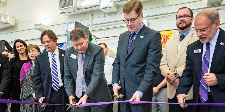 ECU and Wells Fargo officials cut the ribbon on four new CNC machines funded in part by the Wells Fargo Foundation. (Photo by Cliff Hollis) 