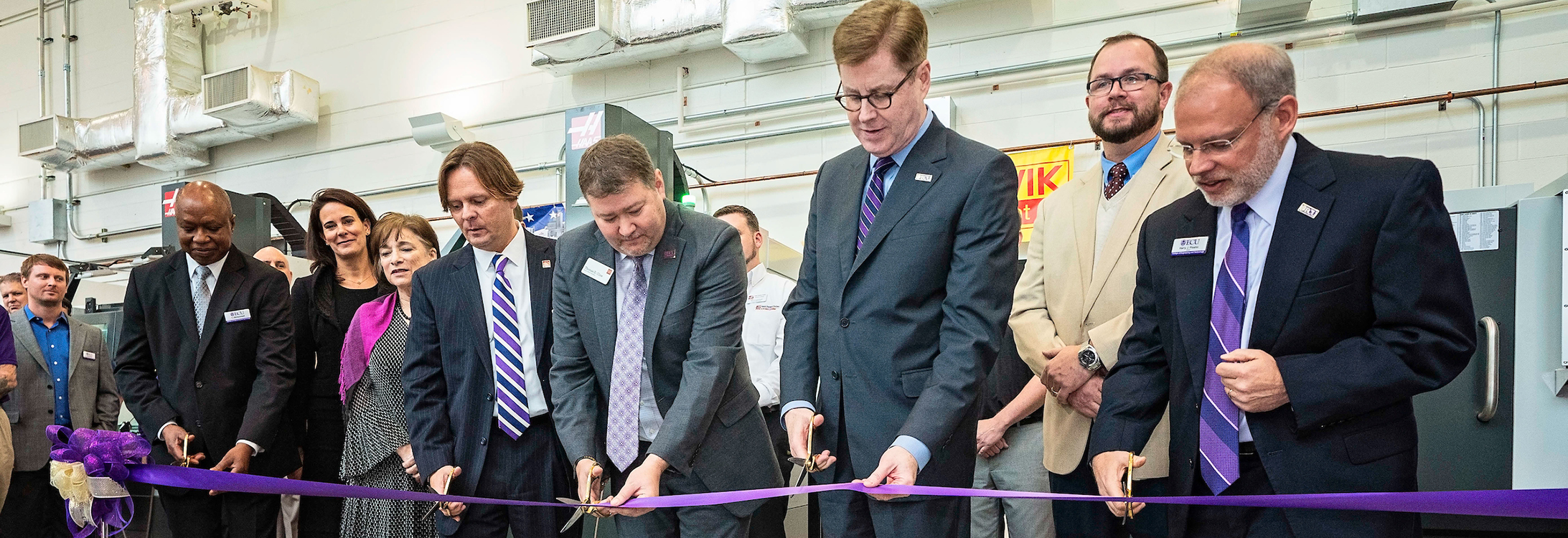 ECU and Wells Fargo officials cut the ribbon on four new CNC machines funded in part by the Wells Fargo Foundation. (Photo by Cliff Hollis) 