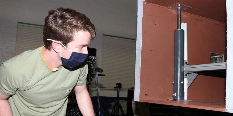 Parker Zieg, a senior engineering major, looks inside the blast simulator to check results from a test. (ECU photos by Ken Buday)