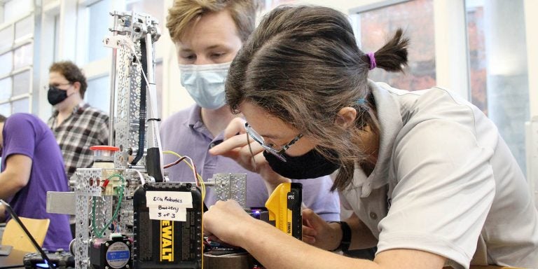 Erica Walker and Van Ravesteyn work on a robot as part of East Carolina University’s chapter of the Association of Technology, Management and Applied Engineering organization. (Photo by Ken Buday)