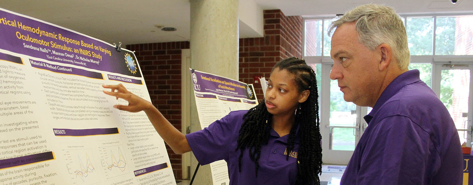 East Carolina University junior biomedical engineering student Sandrena Nalls discusses a research project she worked on during the Biomedical Engineering in Simulations, Imaging and Modeling Research Experience for Undergraduates program Friday in the Science and Technology Building. (Photos by Ken Buday)