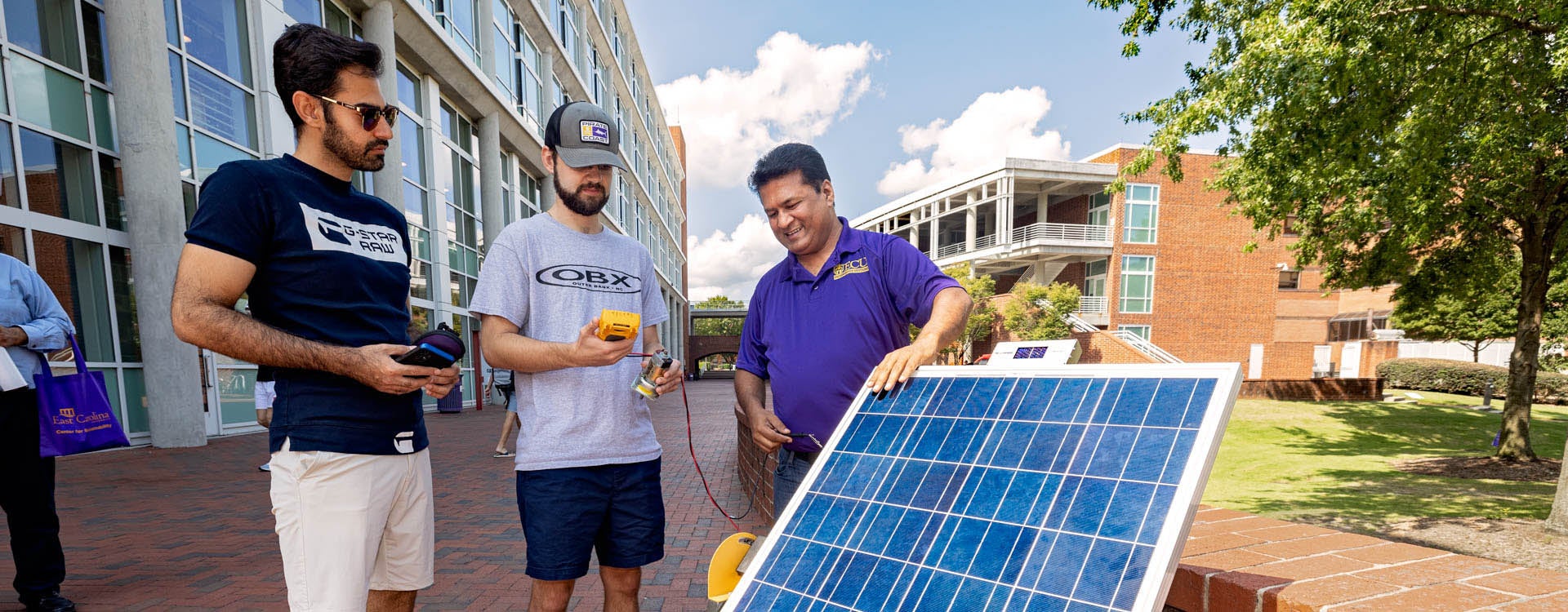 Dr. Ranjeet Agarwala, right, associate professor in the Department of Technology Systems, works with students Behzad Zeinolabedini, left, and Randy Weddle during a solar power demonstration as part of Pollution Prevention Week outside the Science and Technology Building. (Photo by Cliff Hollis)