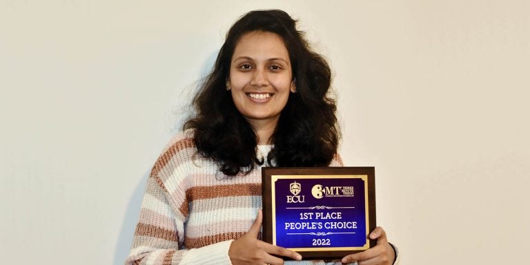 Ashwinee Mehta, a graduate student in the Department of Computer Science, displays her People’s Choice Award from the Graduate School’s annual Three-Minute Thesis (3MT) Competition. (Contributed photo)