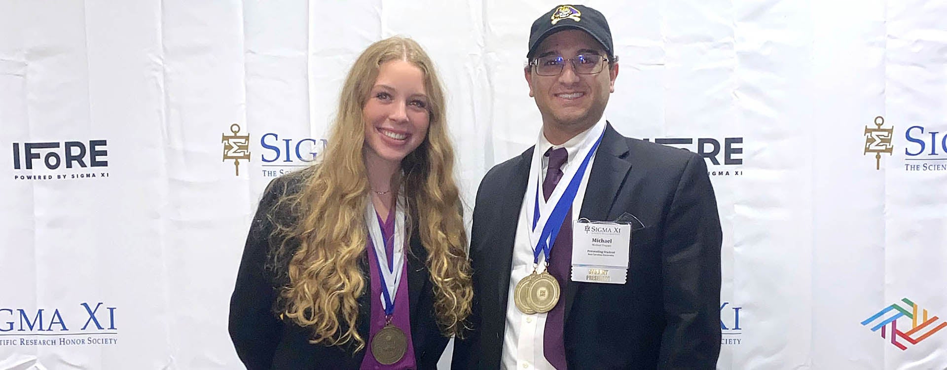 Danielle Werts and Michael Trapani show off their medals from the International Forum on Research Excellence. (Contributed photo)