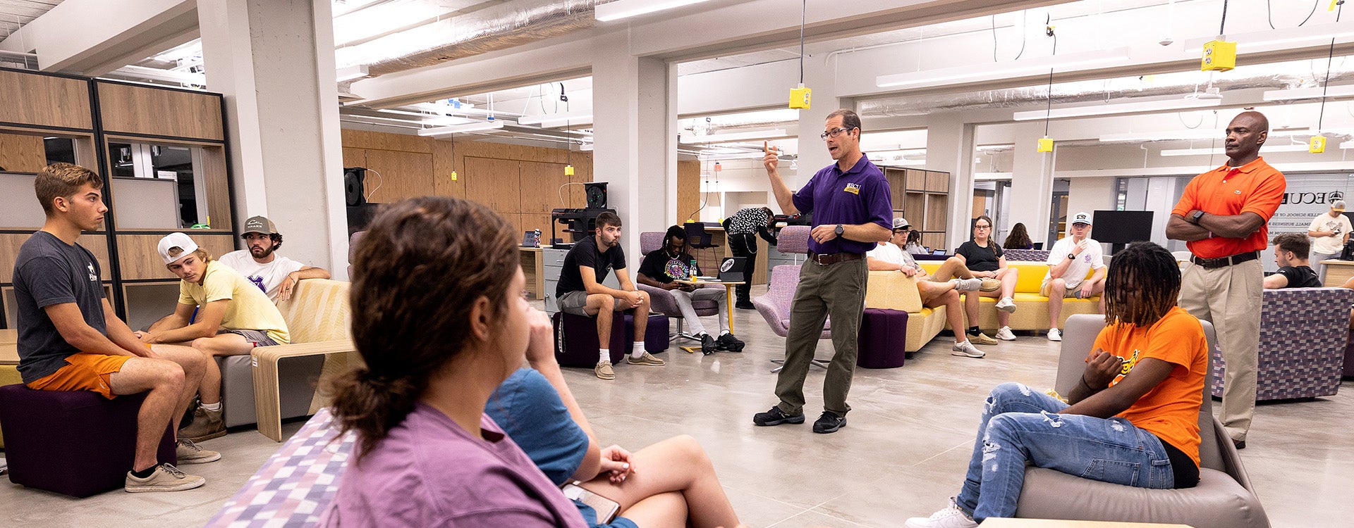 Josh Pitzer, director of lab operations for the College of Engineering and Technology, gives a tour at the Isley Innovation Hub. Pitzer, who helped set up equipment and train student workers at the hub, received a 2022 Treasured Pirate Award. (Photo by Rhett Butler)