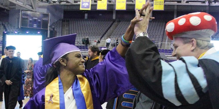Dr. David Batts, associate professor in the Department of Technology Systems, congratulates graduate Mahogany Jade Joachim during the Graduate Recognition Ceremony on Friday at Minges Coliseum. (Photo by Ken Buday)