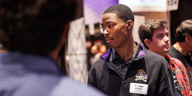 Construction management student Jaden Armstrong meets with employers during the Science, Engineering and Technology Fair Wednesday at the Greenville Convention Center. (Photo by Cliff Hollis)