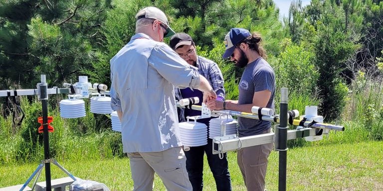 A team of East Carolina University researchers works on an air temperature profile monitoring system at the Coastal Studies Institute. (Contributed photo)