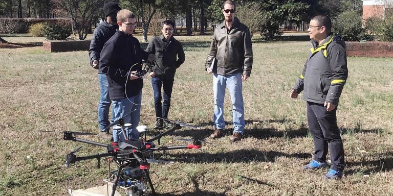 Dr. Zhen Zhu, right, associate professor in the Department of Engineering, works on research exploring advanced applications of UAVs for the Department of Transportation. (Contributed photo)