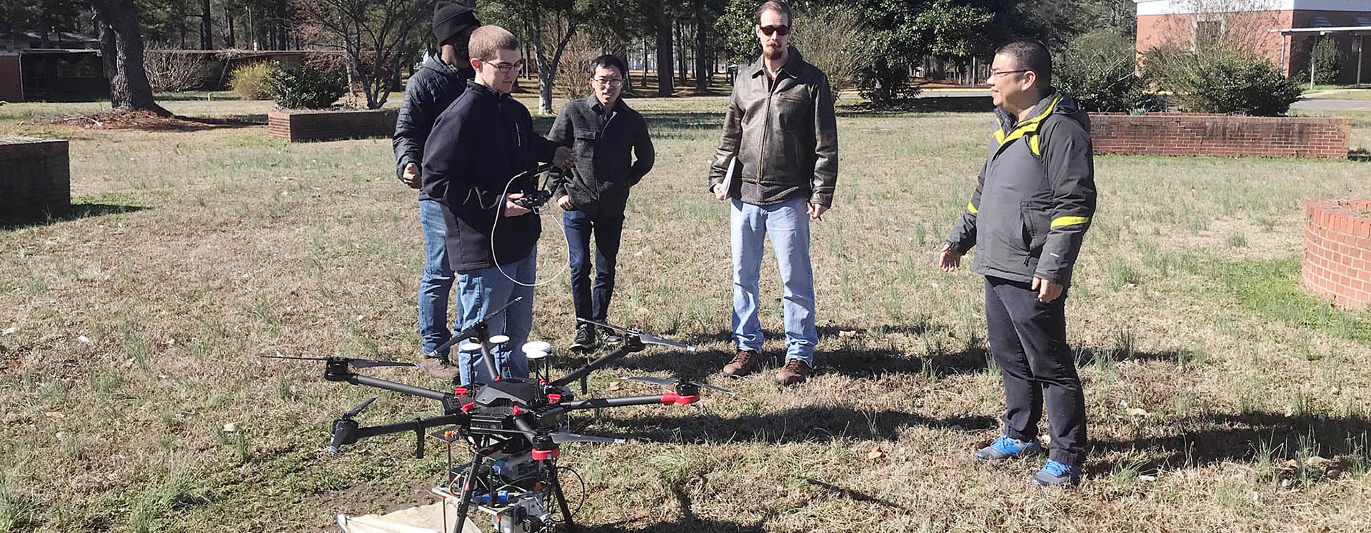 Dr. Zhen Zhu, right, associate professor in the Department of Engineering, works on research exploring advanced applications of UAVs for the Department of Transportation. (Contributed photo)