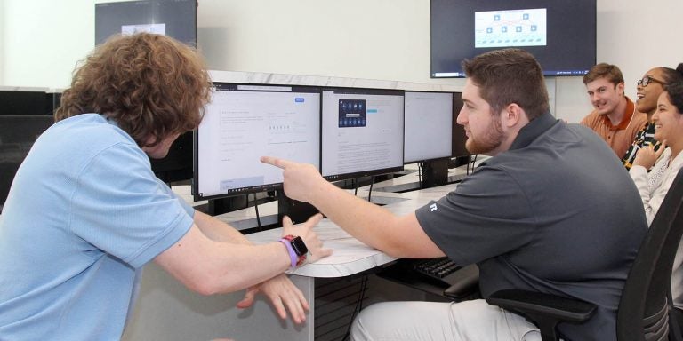 East Carolina University students work in the Cybersecurity Analysis and Action Center in the Science and Technology Building. The lab serves as an instructional hub for information and cybersecurity technology students. (Photo by Ken Buday)