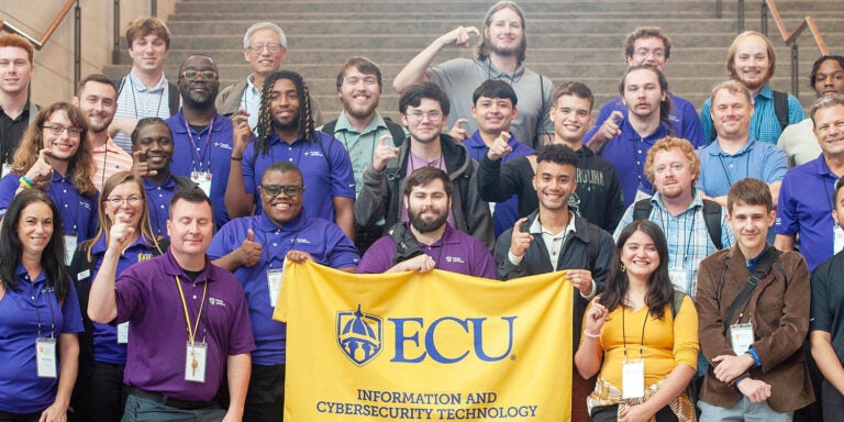 ECU Department of Technology Systems students, faculty and alumni pose for a photograph during the Information Systems Security Association’s InfoSeCon Conference in Raleigh. (Contributed photo)